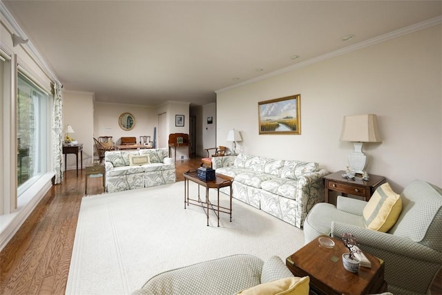 living room with wood finished floors and ornamental molding