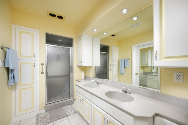 bathroom with a sink, visible vents, and a shower stall