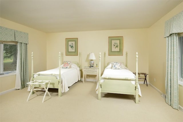 carpeted bedroom featuring baseboards