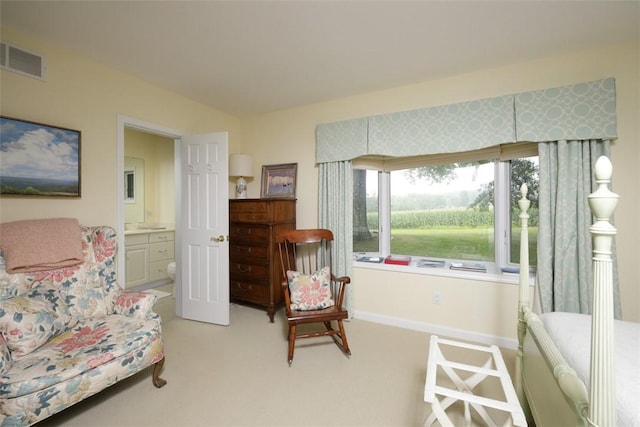 sitting room featuring visible vents, light carpet, and baseboards