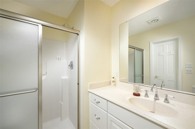 bathroom with a stall shower and vanity