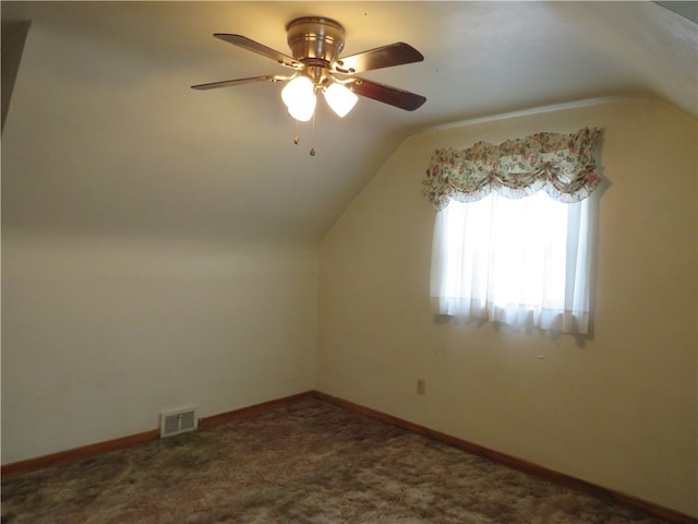 bonus room with lofted ceiling, dark carpet, and ceiling fan