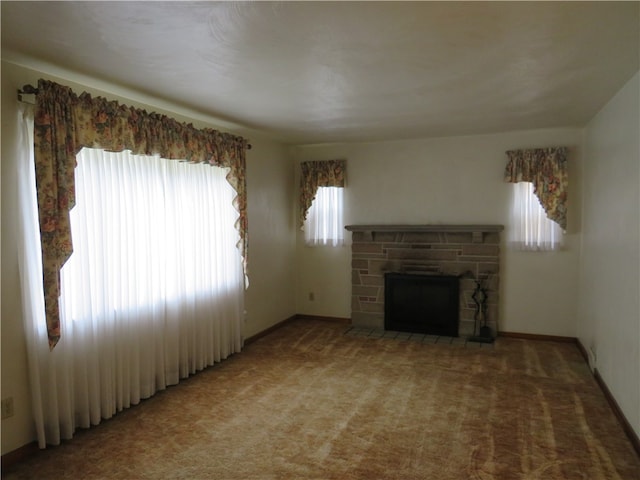 unfurnished living room with a fireplace, a wealth of natural light, and carpet flooring