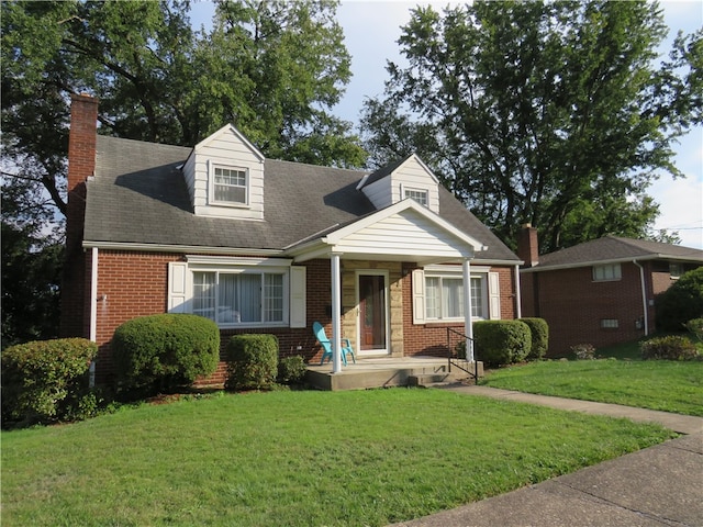 new england style home featuring a front yard