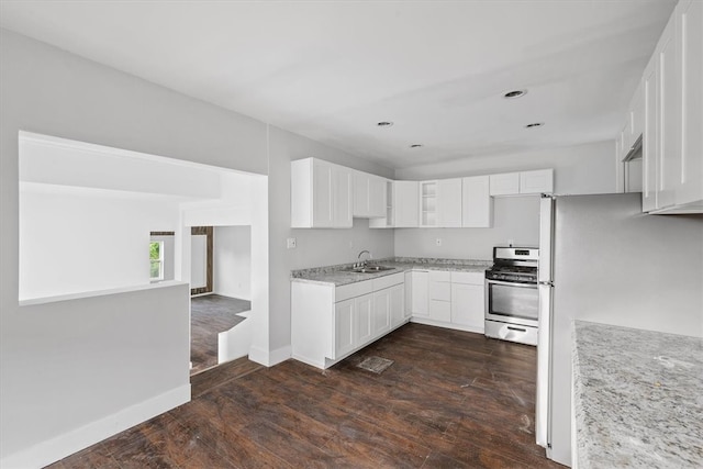 kitchen featuring light stone countertops, dark hardwood / wood-style flooring, gas stove, sink, and white cabinetry