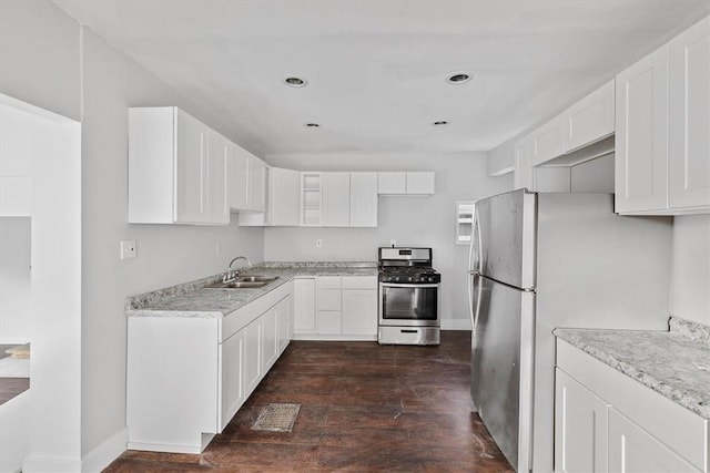 932 Gaskill Ave, Jeannette, PA 15644 - kitchen with stainless steel appliances, a sink, dark wood finished floors, white cabinets, and recessed lighting
