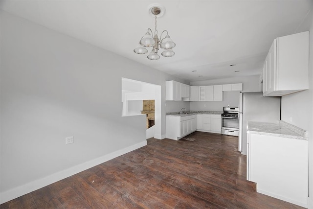 kitchen with a notable chandelier, white cabinetry, sink, dark wood-type flooring, and gas range