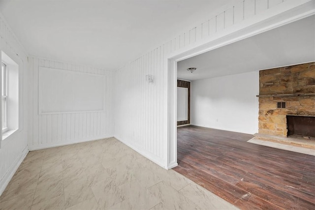 932 Gaskill Ave, Jeannette, PA 15644 - unfurnished room with a fireplace, baseboards, and wood finished floors