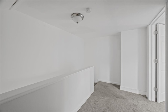 hallway with light colored carpet