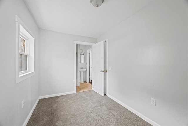 spare room with carpet flooring and sink