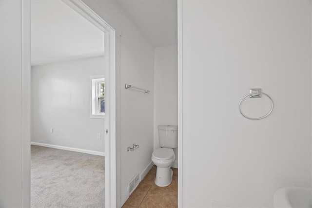 bathroom with tile patterned flooring and toilet