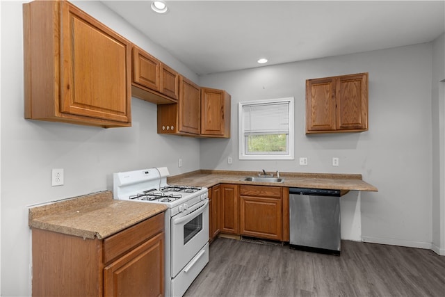 kitchen featuring light stone counters, white stove, wood-type flooring, stainless steel dishwasher, and sink