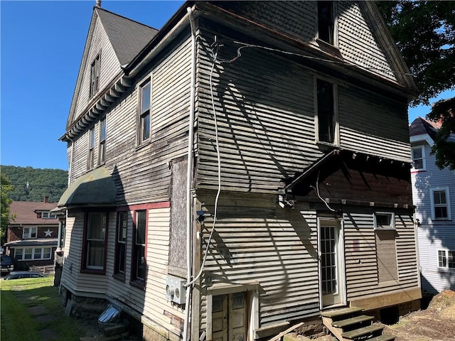 view of side of property with entry steps