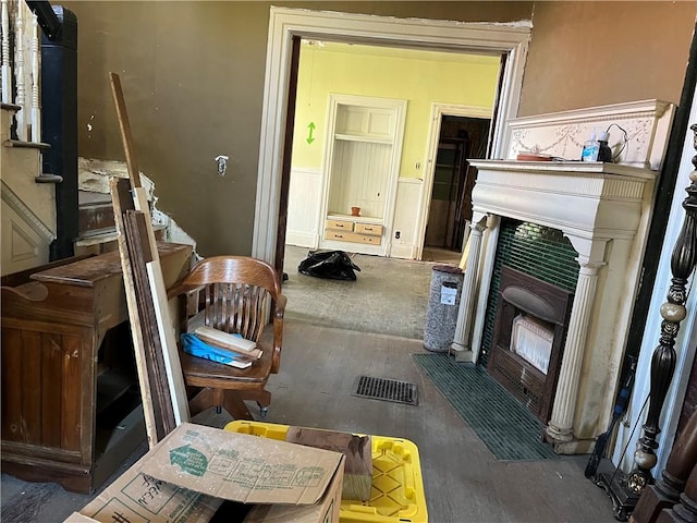 interior space with visible vents, a wainscoted wall, stairway, and wood finished floors