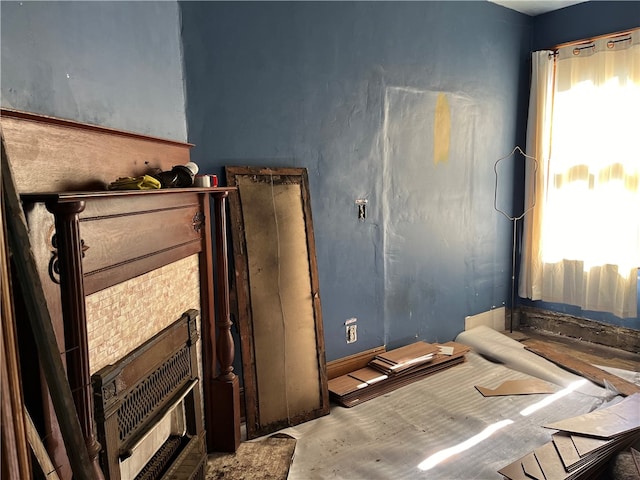 bedroom with a fireplace and multiple windows