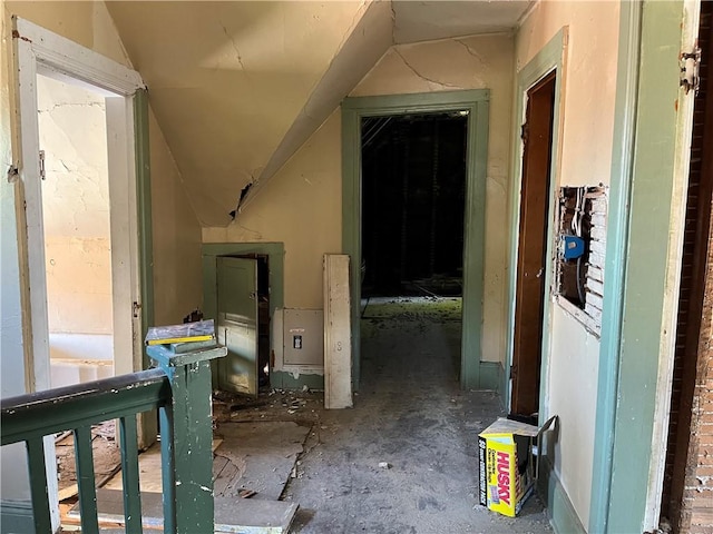 hall featuring lofted ceiling