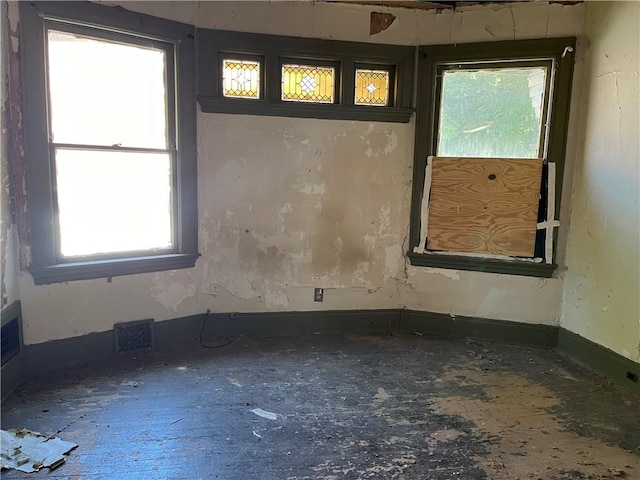spare room with baseboards