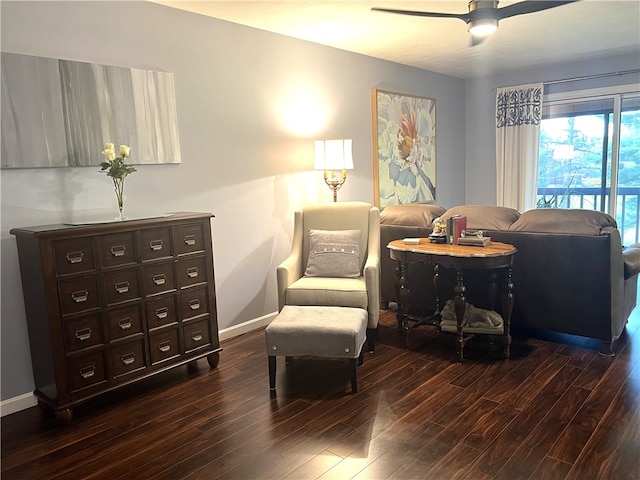 sitting room featuring dark wood-type flooring and ceiling fan