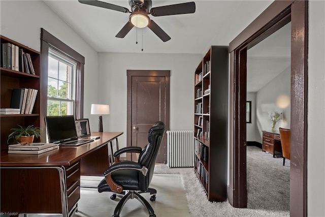 carpeted office featuring radiator heating unit and ceiling fan