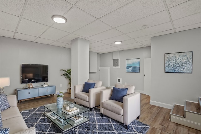 living room featuring hardwood / wood-style flooring and a paneled ceiling