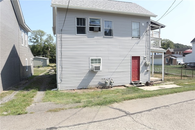 exterior space with a balcony and cooling unit