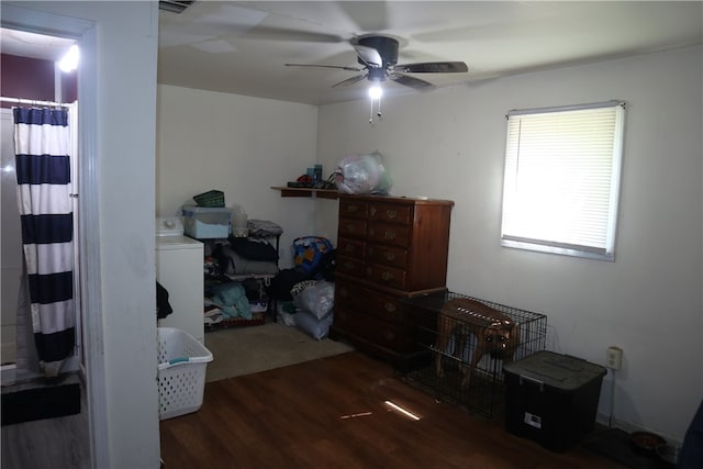 interior space with dark wood-type flooring, ceiling fan, and washer / dryer