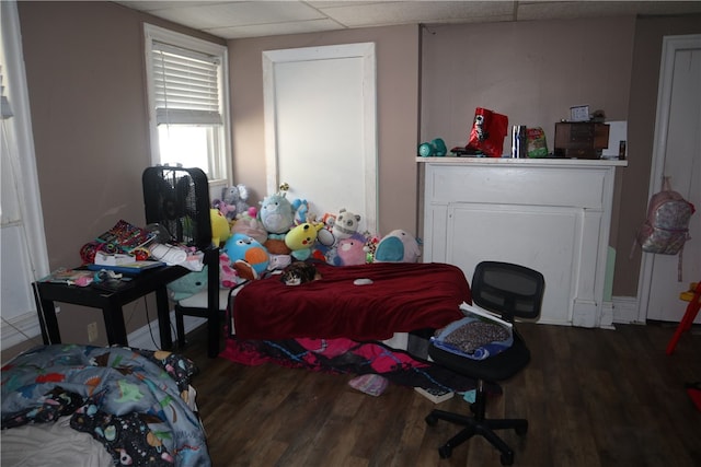 bedroom featuring hardwood / wood-style floors and a paneled ceiling