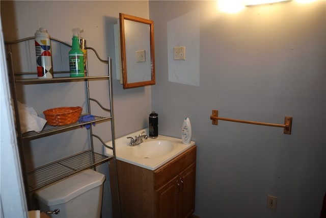 bathroom featuring toilet and vanity