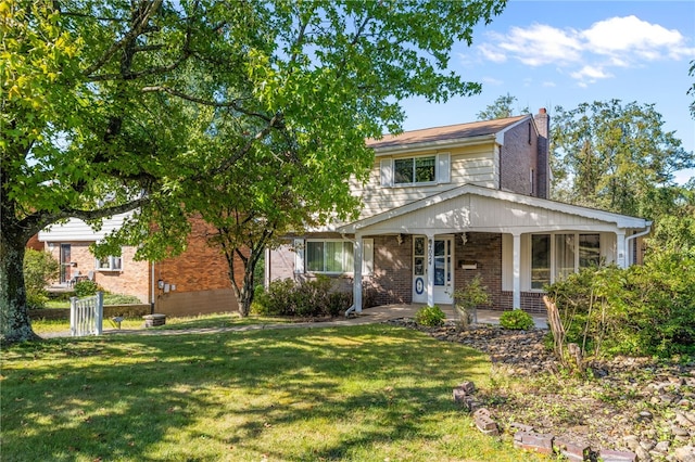 view of front facade featuring a front lawn and covered porch