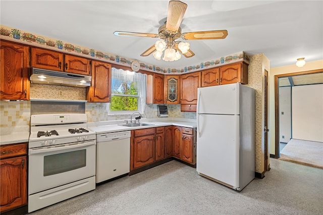 kitchen with white appliances, backsplash, sink, and ceiling fan