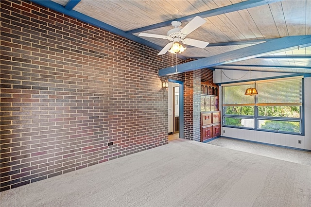 spare room with lofted ceiling with beams, brick wall, ceiling fan, and carpet flooring