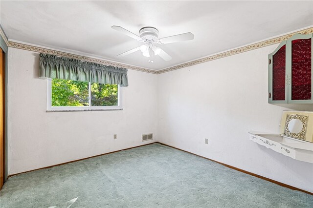 empty room with ceiling fan and carpet flooring