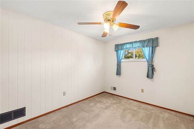 spare room featuring ceiling fan and light colored carpet