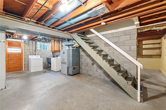 basement featuring washer and dryer and heating unit