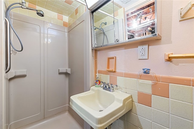 bathroom featuring walk in shower and sink