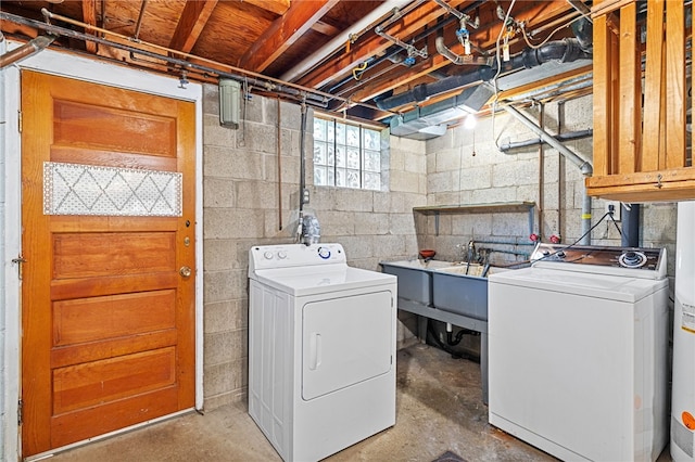 washroom with cabinets, washer and dryer, and sink