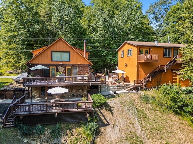 rear view of property featuring a wooden deck