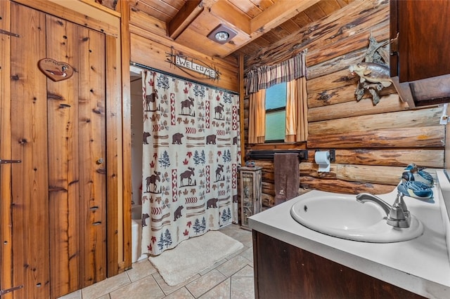 bathroom with log walls, vanity, shower / bath combination with curtain, wooden ceiling, and beam ceiling