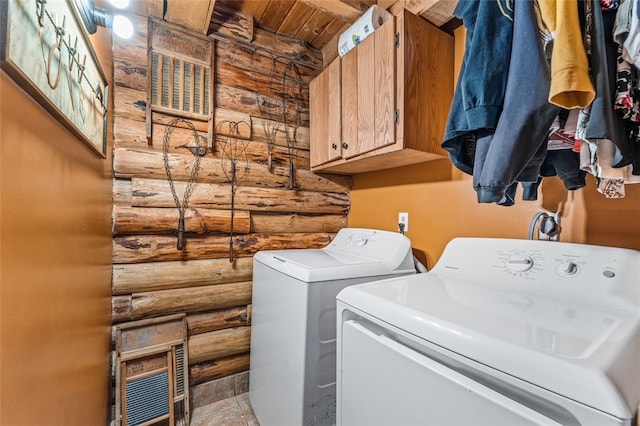 washroom featuring log walls, cabinets, and separate washer and dryer