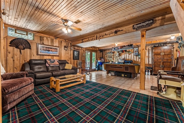 living room with ceiling fan, wood ceiling, wooden walls, and tile patterned floors