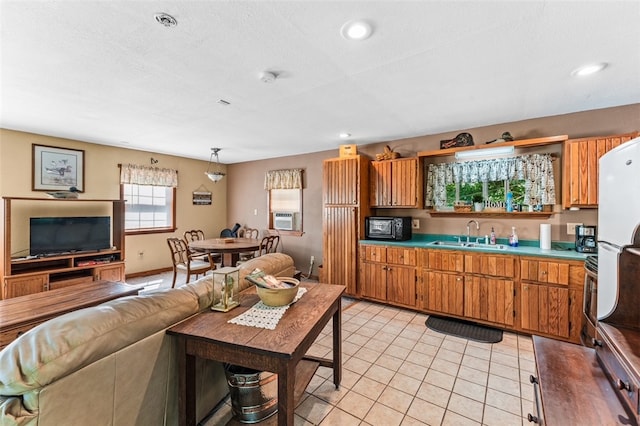 kitchen featuring sink, white fridge, and light tile patterned flooring