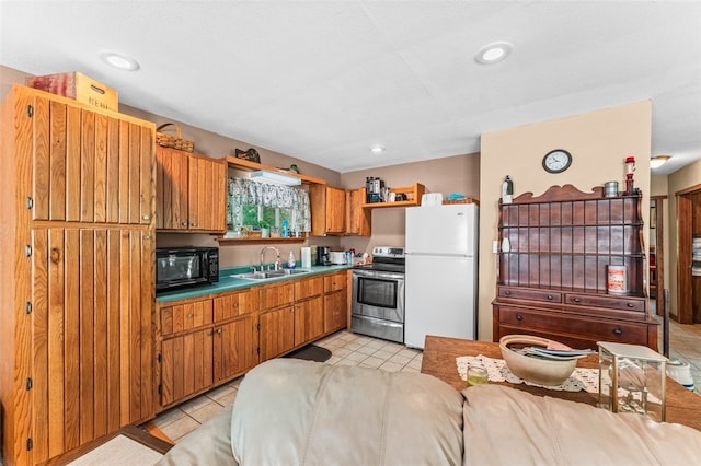 kitchen with white fridge, light tile patterned floors, stainless steel electric stove, and sink