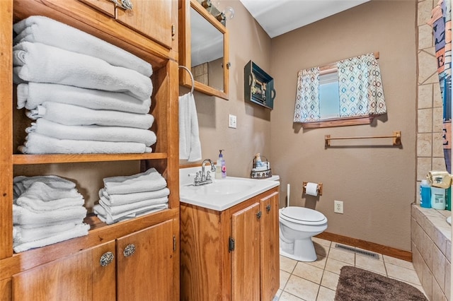 bathroom with vanity, toilet, and tile patterned flooring