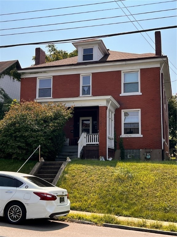 view of front of home with a front lawn and covered porch