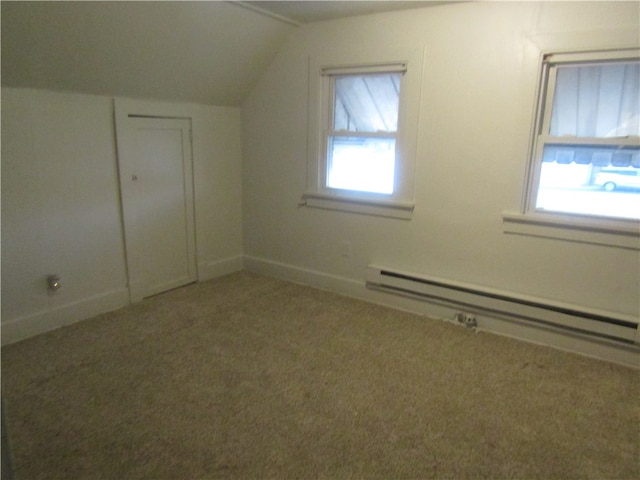 bonus room featuring lofted ceiling, a baseboard radiator, light colored carpet, and a healthy amount of sunlight