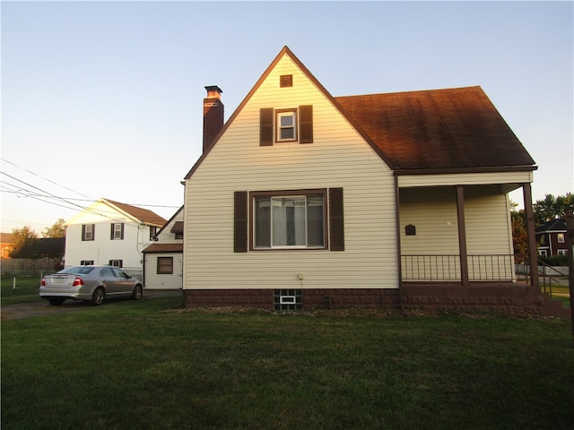 back house at dusk with a yard