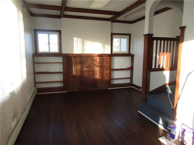 unfurnished living room featuring dark hardwood / wood-style flooring and beamed ceiling