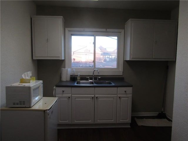 203 W George, Carmichaels/Cumblnd, PA 15320 - kitchen with a sink, dark wood-type flooring, baseboards, white microwave, and white cabinetry