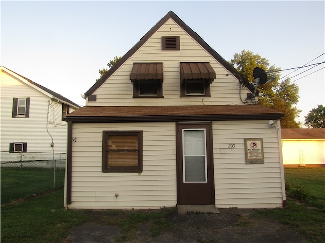 rear view of house with a yard