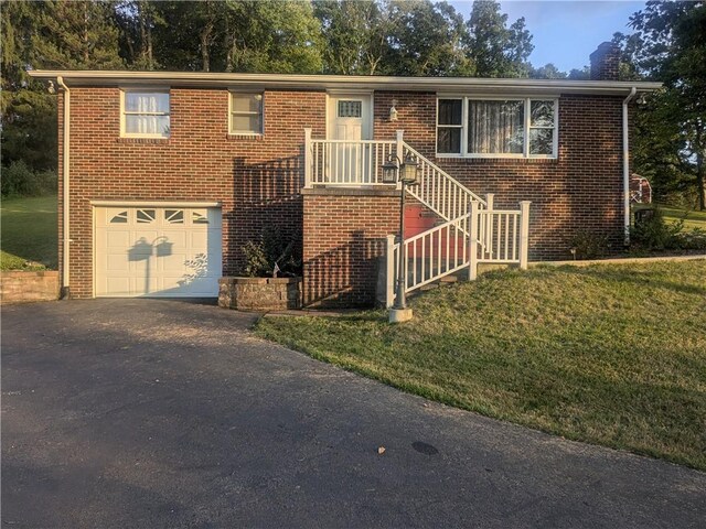 view of front of property with a front yard and a garage